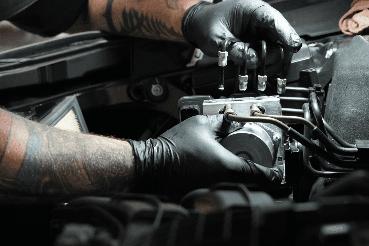 Gloved technician inspecting an engine