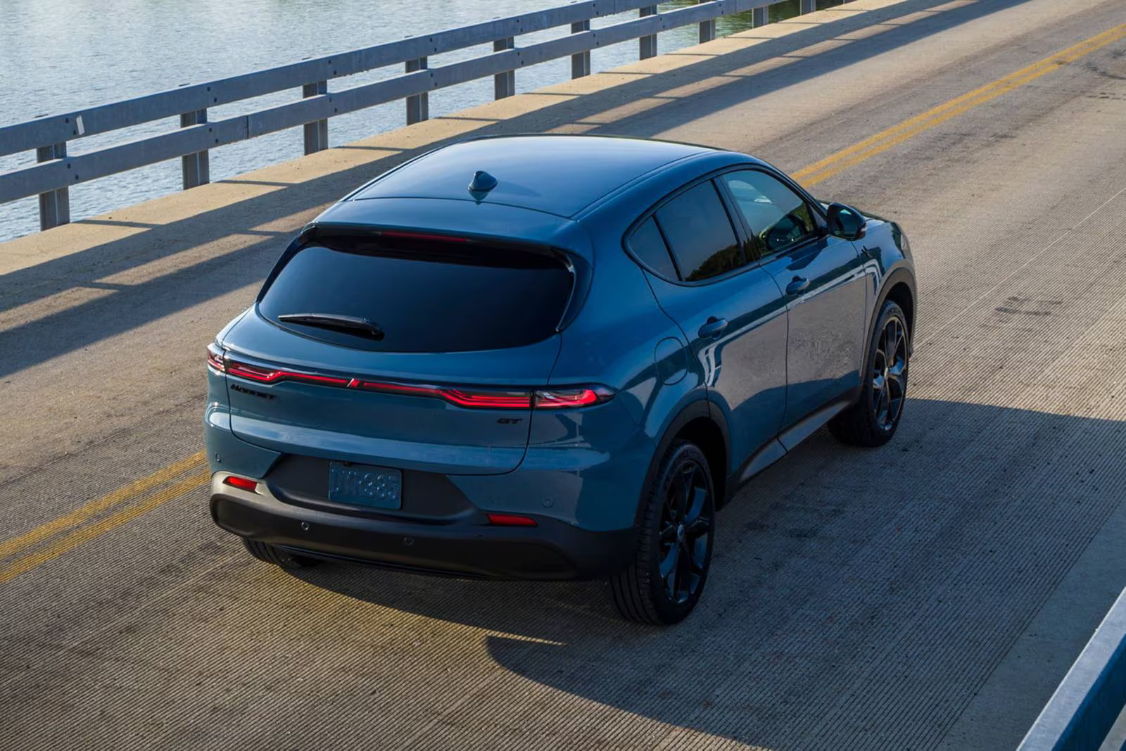 A blue car driving on the road.