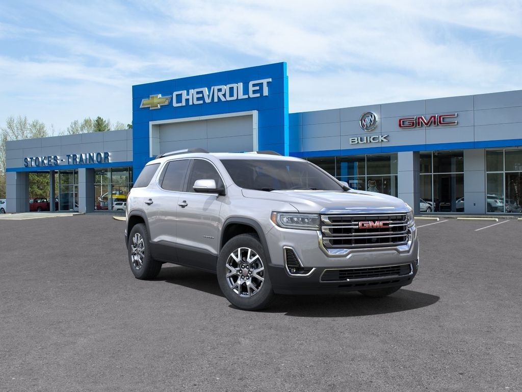 silver 2023 gmc acadia in parked in front of a dealership