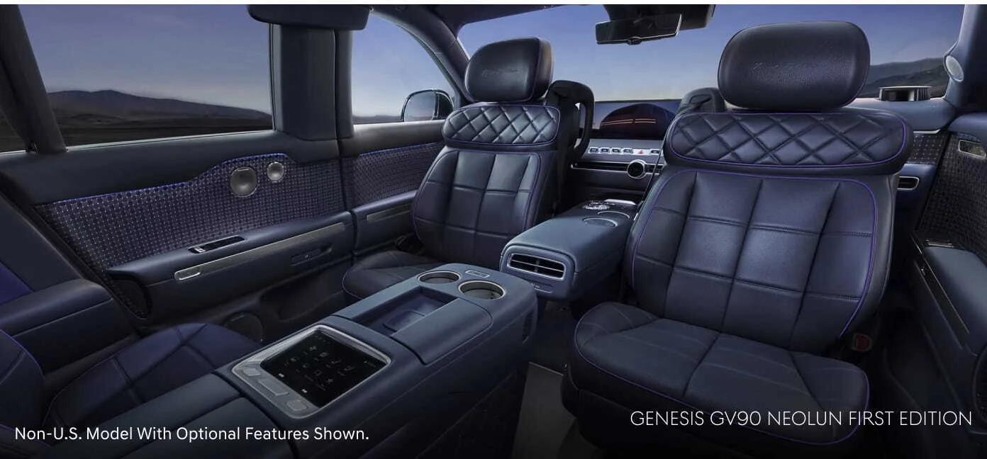 Genesis GV90 Neolun First Edition interior with dark leather captain’s chairs, center consoles, and ambient lighting.