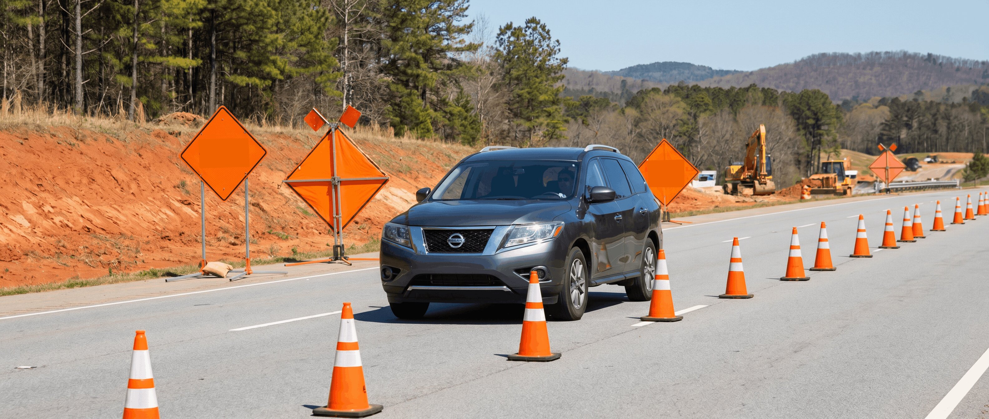 Nissan vehicle navigating summer road construction in Roswell, GA