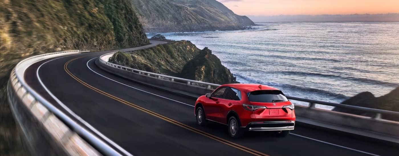 A red 2024 Honda HR-V for sale near Medina is shown from the rear at an angle.