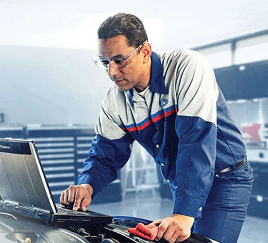 image of ford employee working on laptop