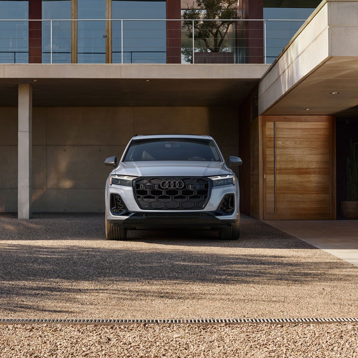 2026 Audi Q7 three-row SUV parked in front of a modern home, front view