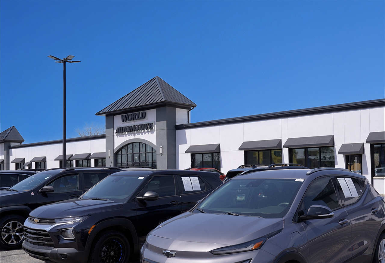 Exeterior of World Automotive Used Car dealership on a sunny day