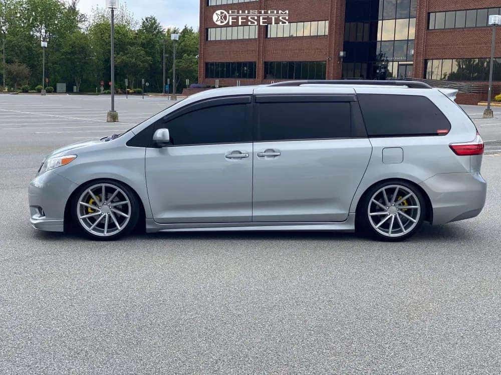 Lowered silver minivan with custom wheels and tires