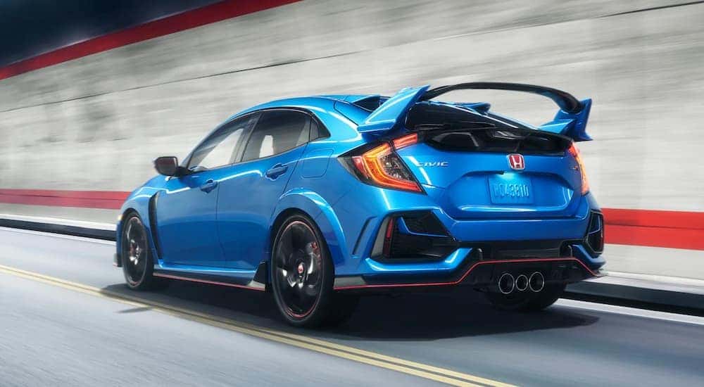 A blue 2021 Honda Civic Type R is shown from the rear while driving.
