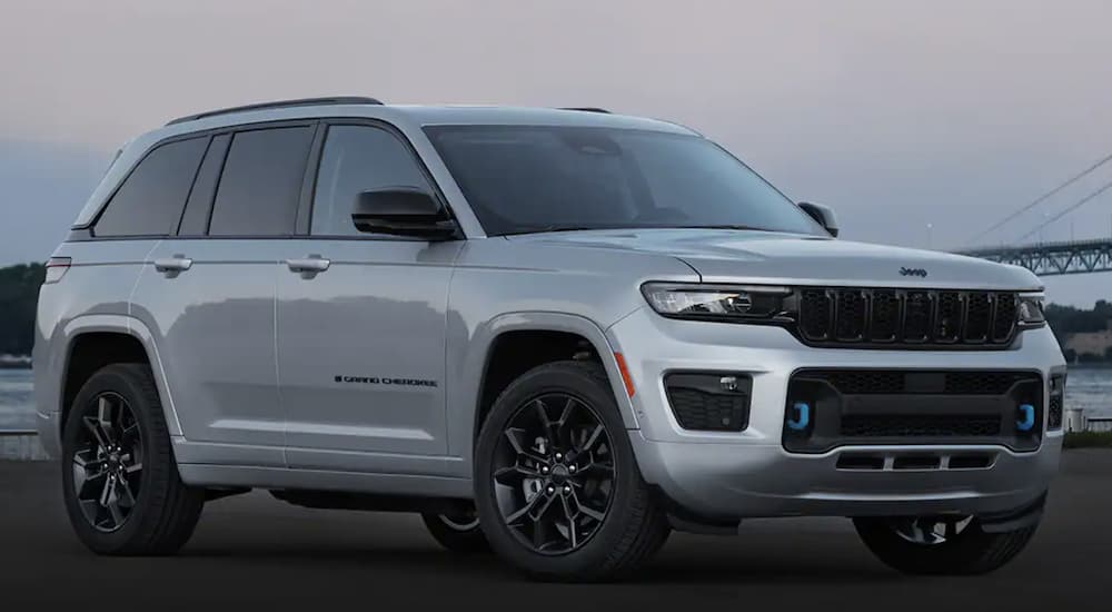 A silver 2023 Jeep Grand Cherokee 4xe angled right.