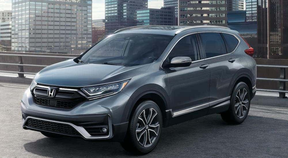 One of the many popular new Honda SUVs, A silver 2021 Honda CR-V, is shown parked on a rooftop garage.