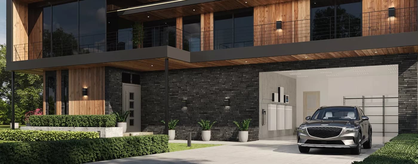 Grey 2026 Genesis GV60 parked outside of a modern home