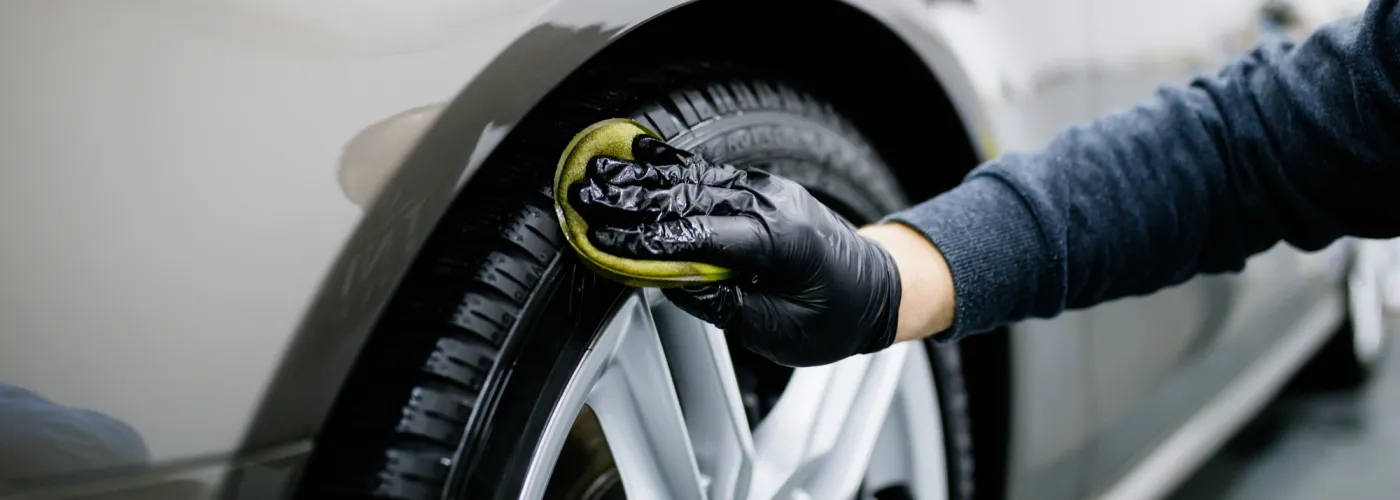 Hand Wiping Down Car Tire