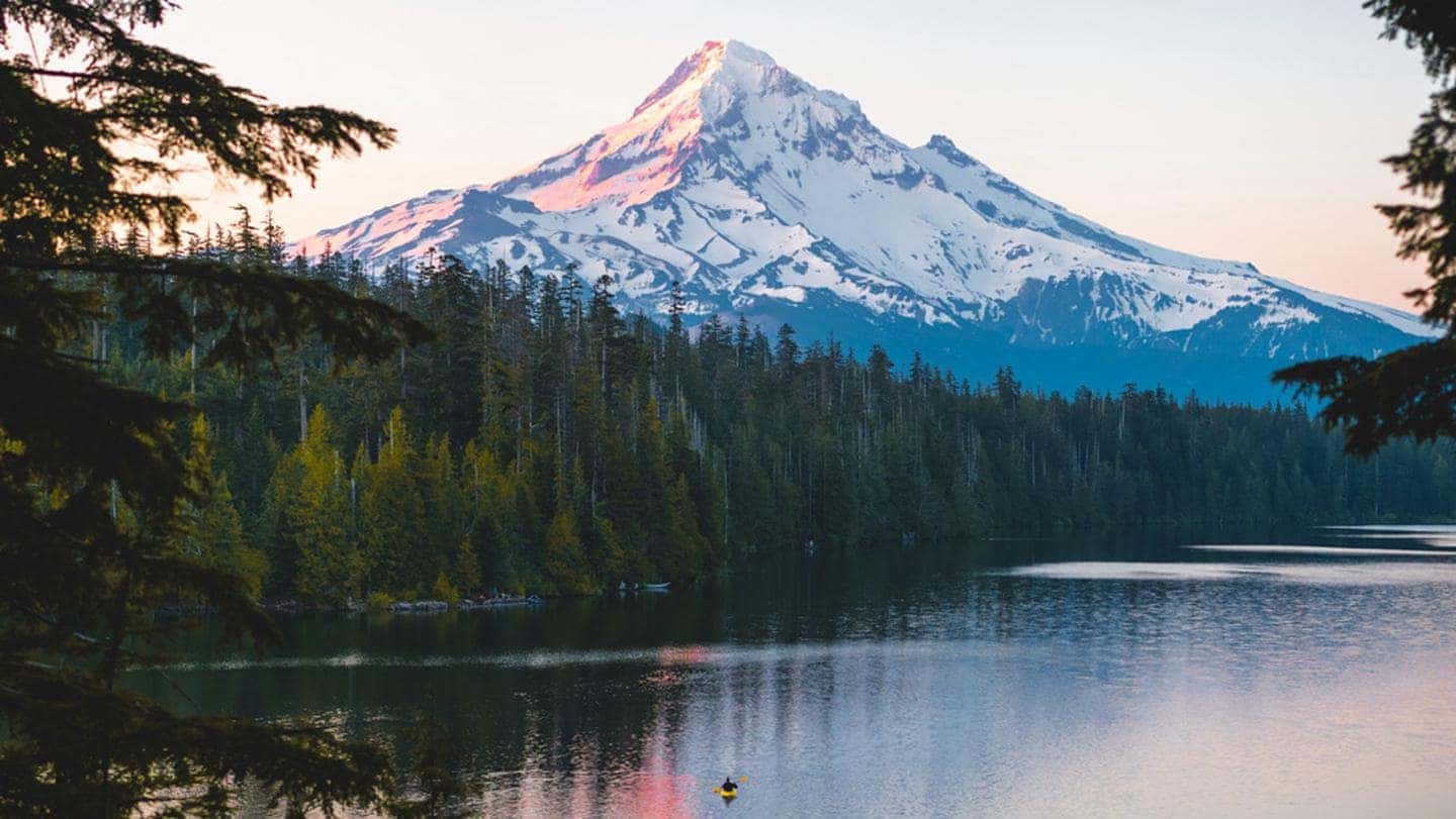 Mount Hood above a lake surrounded by forest