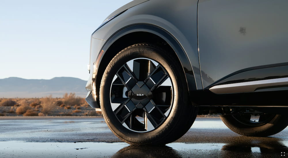 Close-up on the wheels of a blue 2026 Kia Sportage Hybrid.