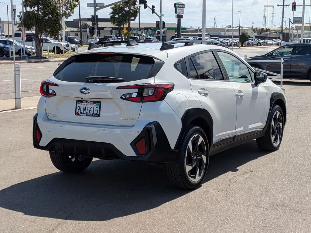 Rear three-quarter view of the white used 2024 Subaru Crosstrek Premium on the Dalton Subaru lot