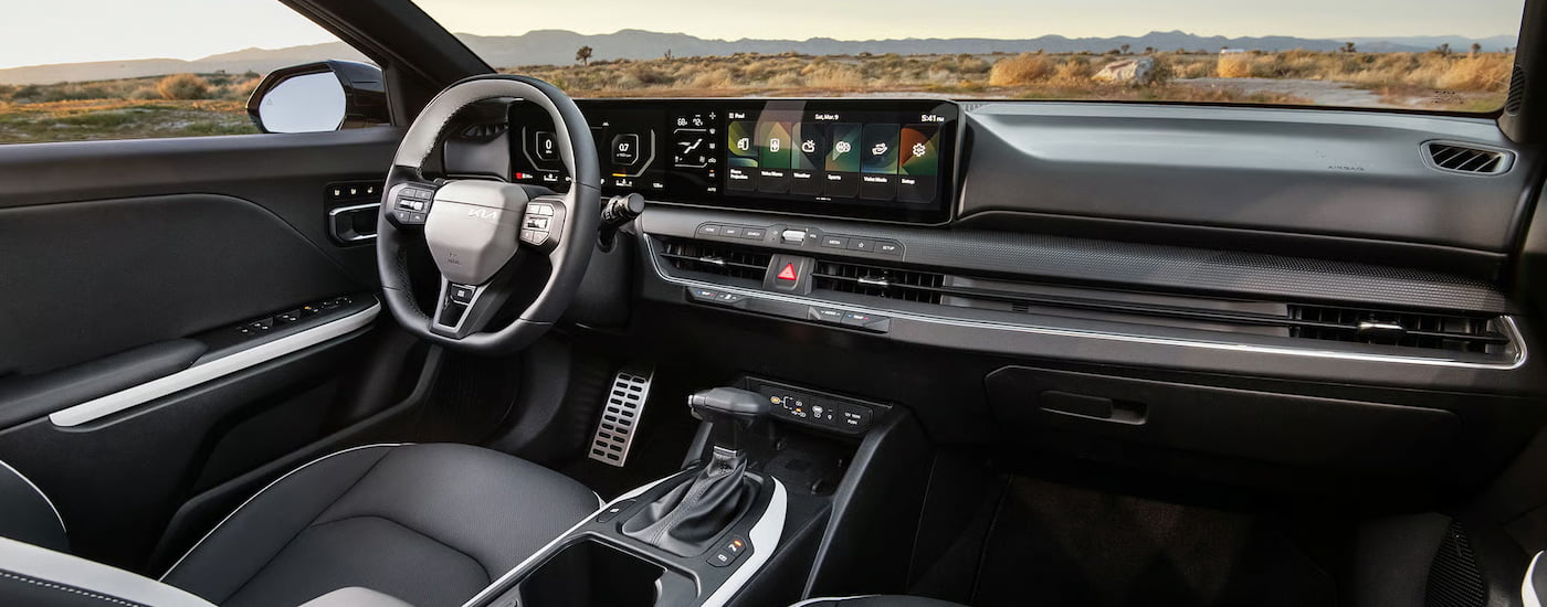 Steering wheel and dashboard in the interior of a 2026 Kia K4.