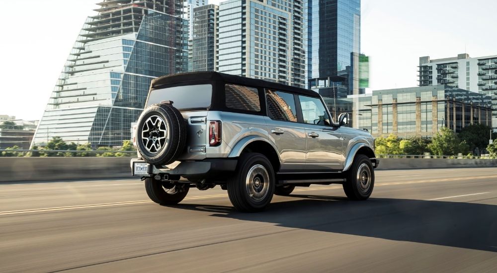 Silver 2021 Ford Bronco driving on a city street