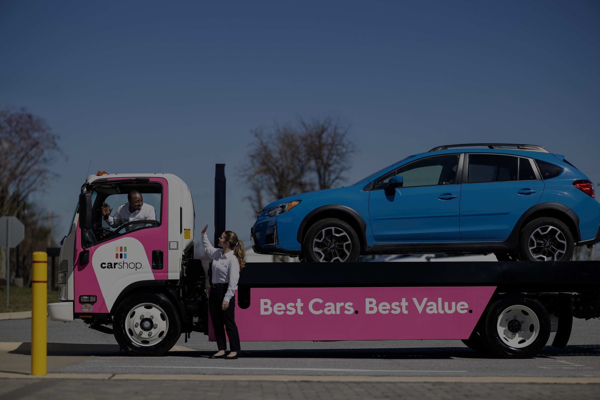 Carshop truck delivering blue car