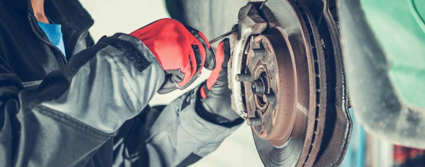 A tech is shown replacing brake pads.