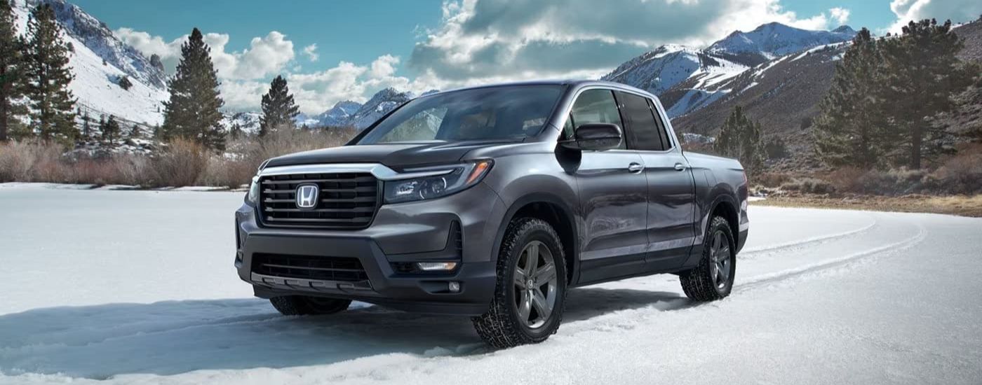 Grey 2021 Honda Ridgeline RTL-E is shown parked in a snowy field
