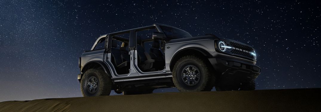 Gray 2024 Ford Bronco in a Desert at Night with Roof and Doors Removed