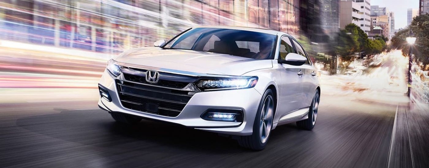 A white 2020 Honda Accord is shown from the front at an angle.