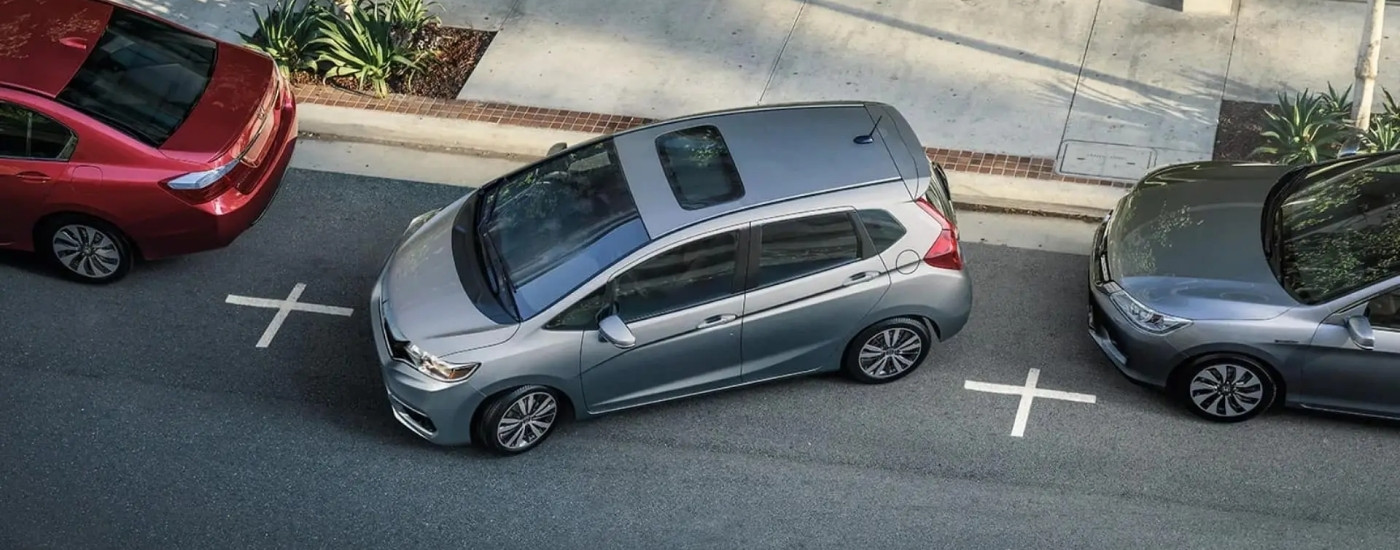 Silver 2020 Honda Fit EX-L parallel parking in a city