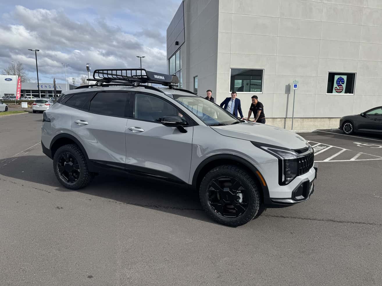 Kia Sportage with roof basket parked outside