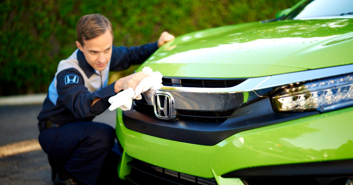Honda Service Tech scrubbing a Honda