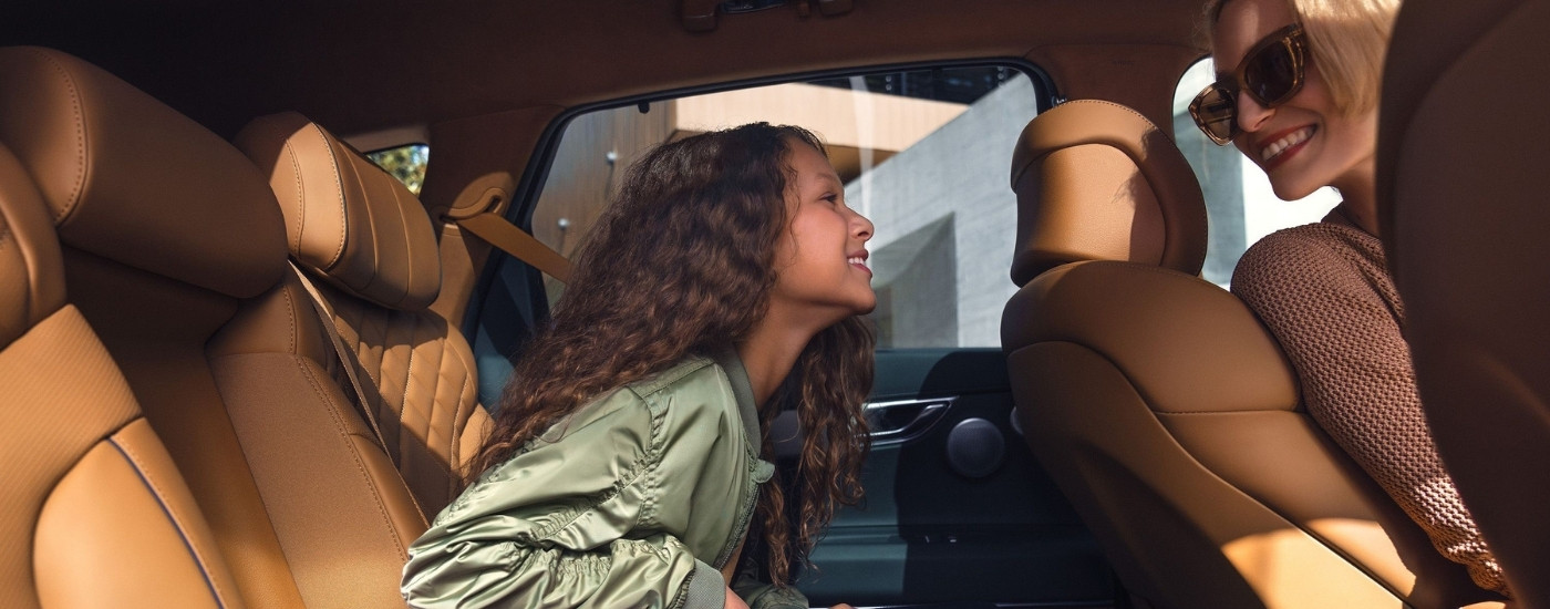 Smiling people in a 2026 Genesis GV80 for sale