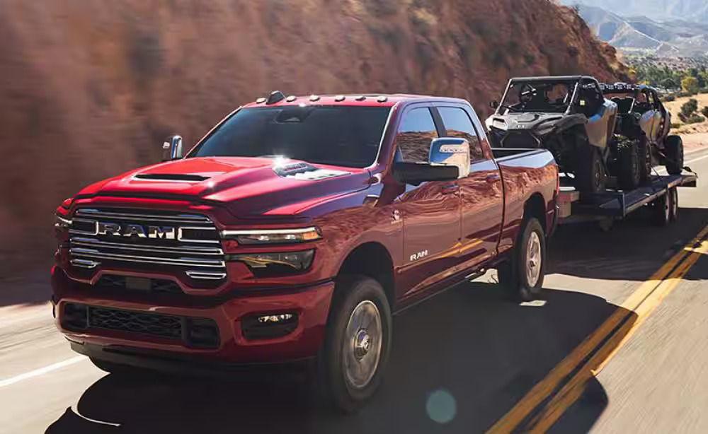 A red truck pulling a a trailer.