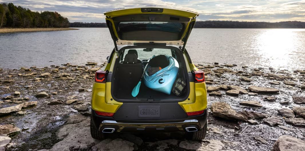 2024 Chevrolet Trailblazer with an open trunk holding a kayak, demonstrating its versatile cargo space and outdoor adventure capability.