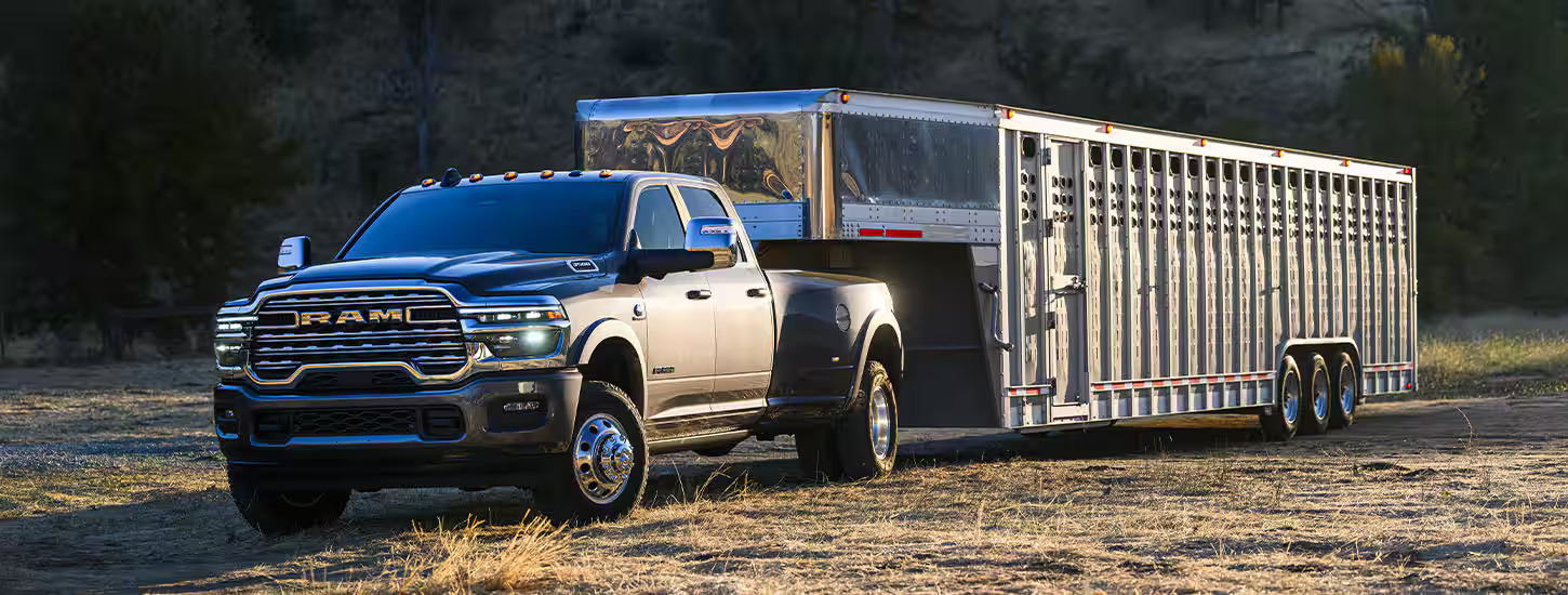 A ram truck parked with a trailer.