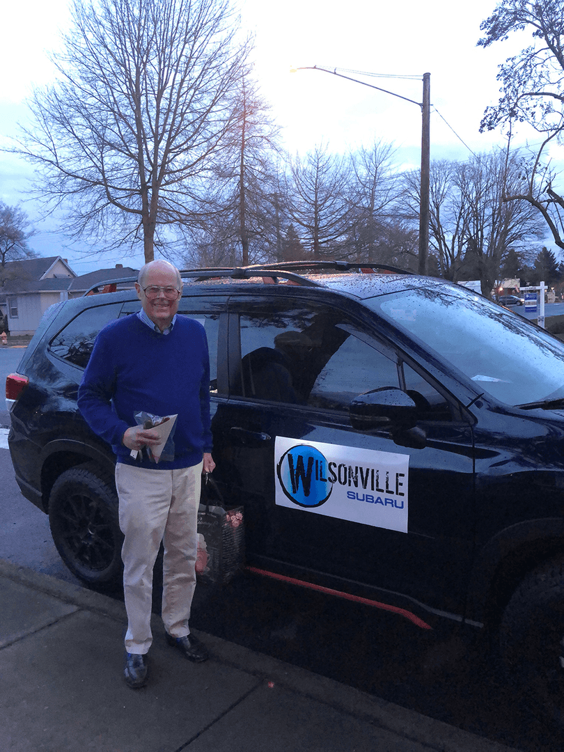Man standing beside a Wilsonville Subaru vehicle