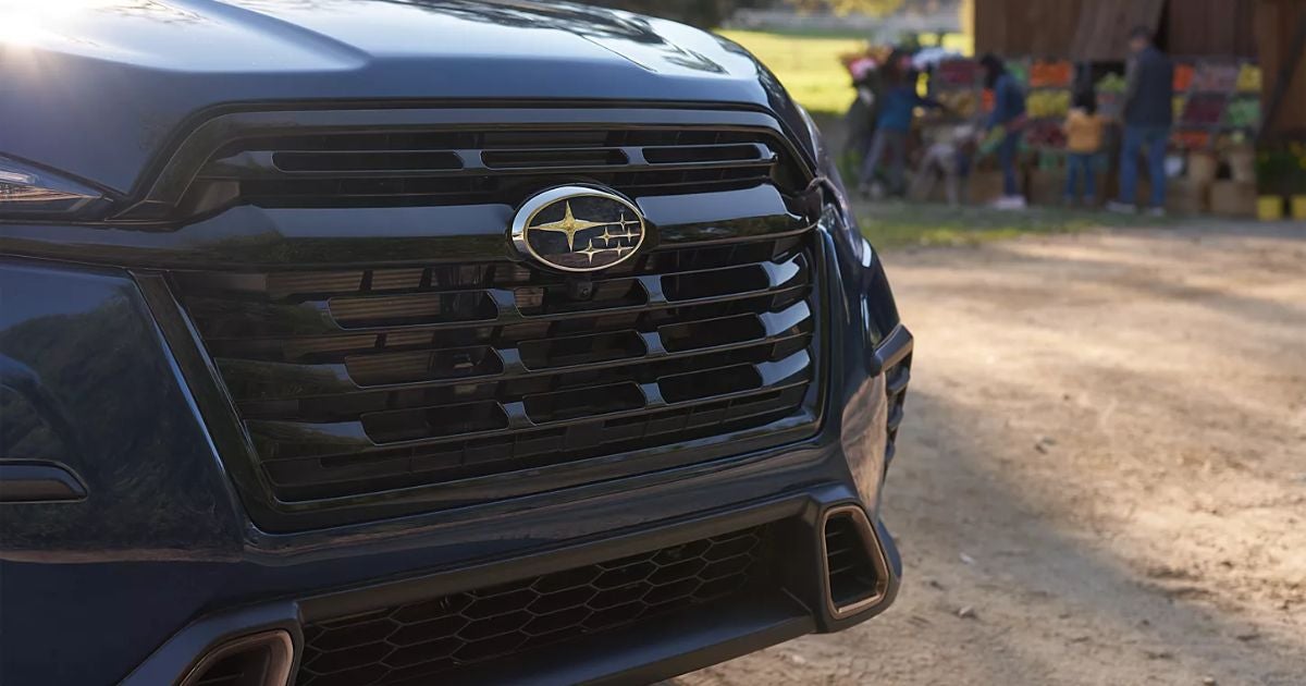 Close-up of the front grille and Subaru badge on a dark blue Subaru Ascent