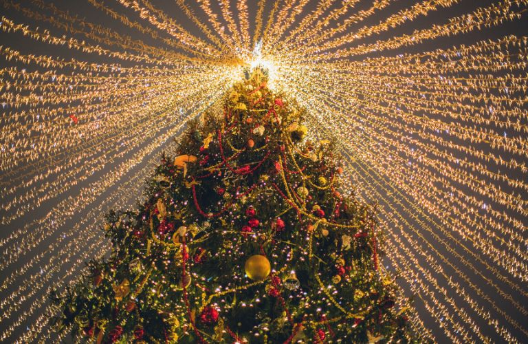 Looking Up at Christmas Tree with Ornaments and Lights and Lights Hanging Down