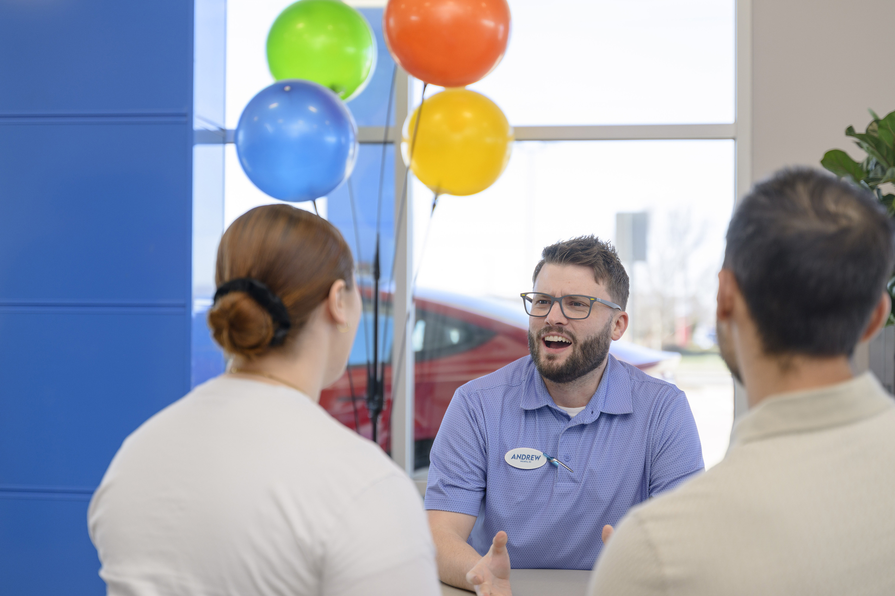 Finance manager at Don Hattan Dealerships talking with customers about the best financing options available in the Wichita area
