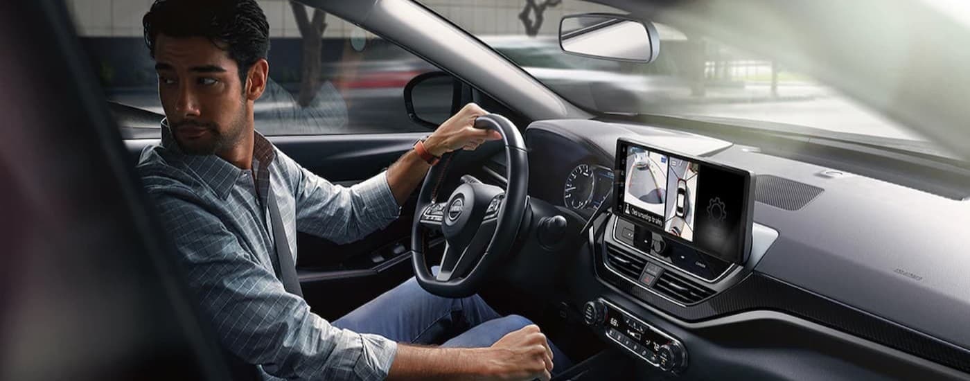 A person driving in a 2024 Nissan Altima SR.