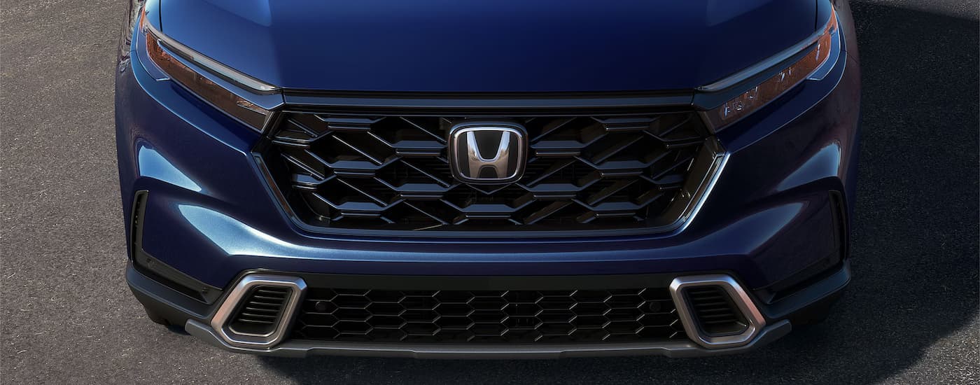 Grille and front of a dark blue 2025 Honda CR-V Hybrid for sale