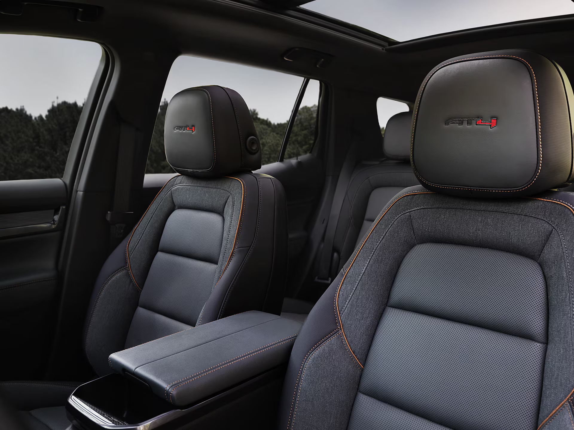 GMC Terrain AT4 interior with black seats, copper stitching, and a panoramic sunroof