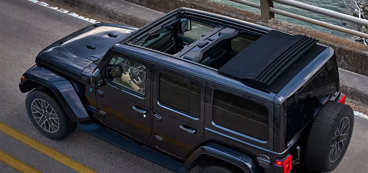 A jeep with the sunroof open.