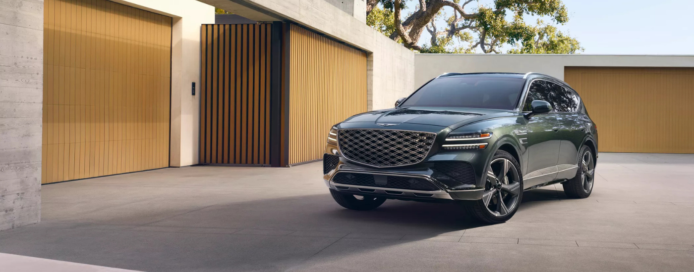 Green 2025 Genesis GV80 parked in front of a home