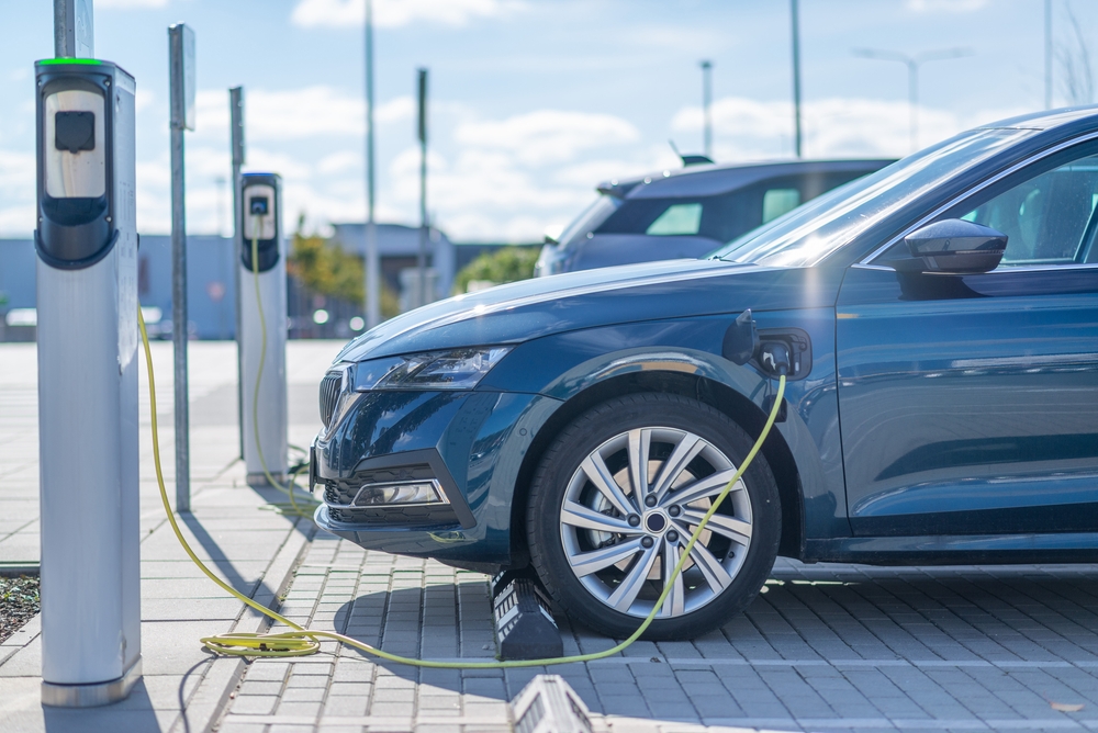 Electric vehicle plugged into a charging station