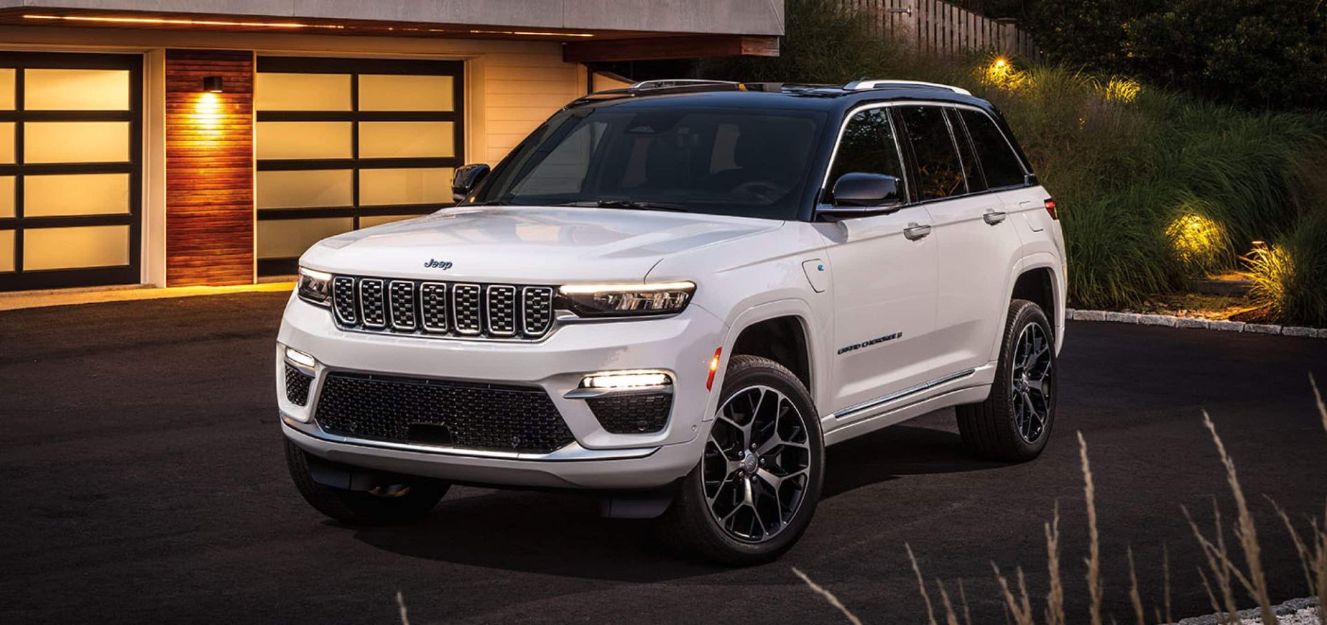 A white suv sitting parked in a driveway.
