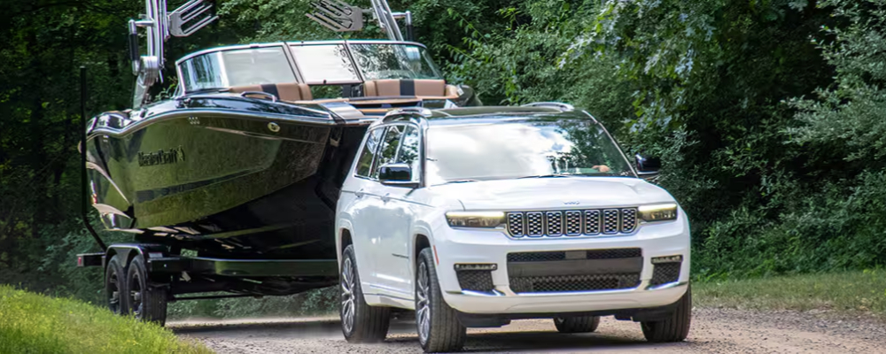 A jeep pulling a boat.