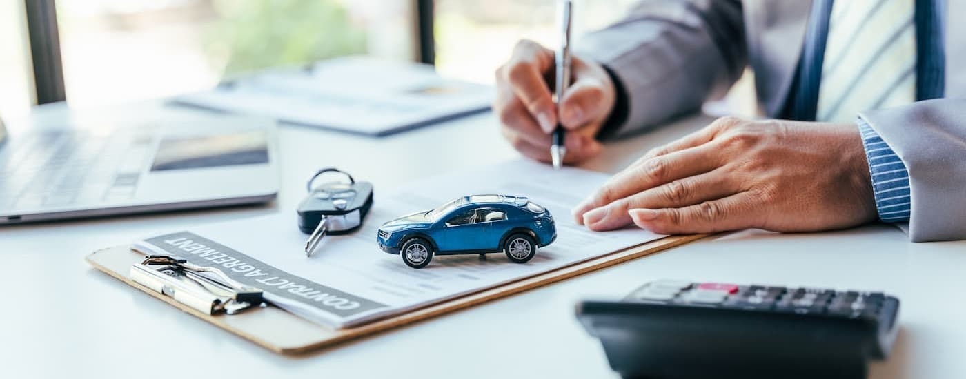 A sales person signing papers.