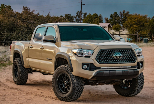 Toyota Tacoma Used Truck in brown paint style and offroad tires.