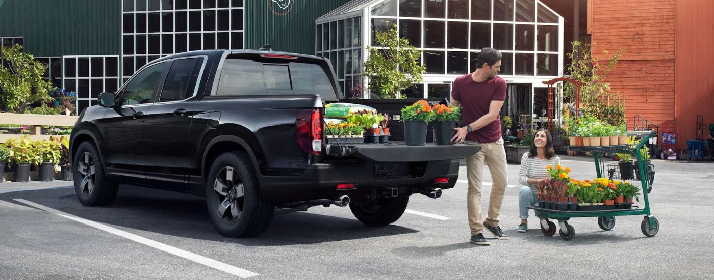 Black 2025 Honda Ridgeline RTL parked near a plant nursery