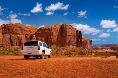 White certified used Chevy SUV parked in a desert environment. 