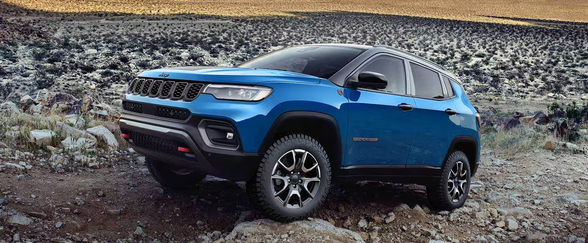 A blue Jeep Compass sitting parked.