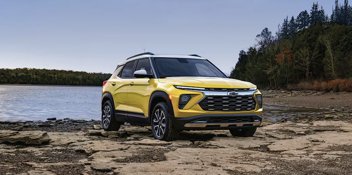 Yellow 2024 Chevrolet Trailblazer SUV parked by a riverbank